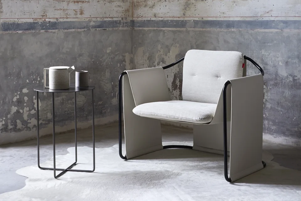 Kimono fauteuil d’Amura Lab associe structure métallique et cuir raffiné dans une harmonie inspirée du vêtement japonais. Disponible chez D-Style Interior.